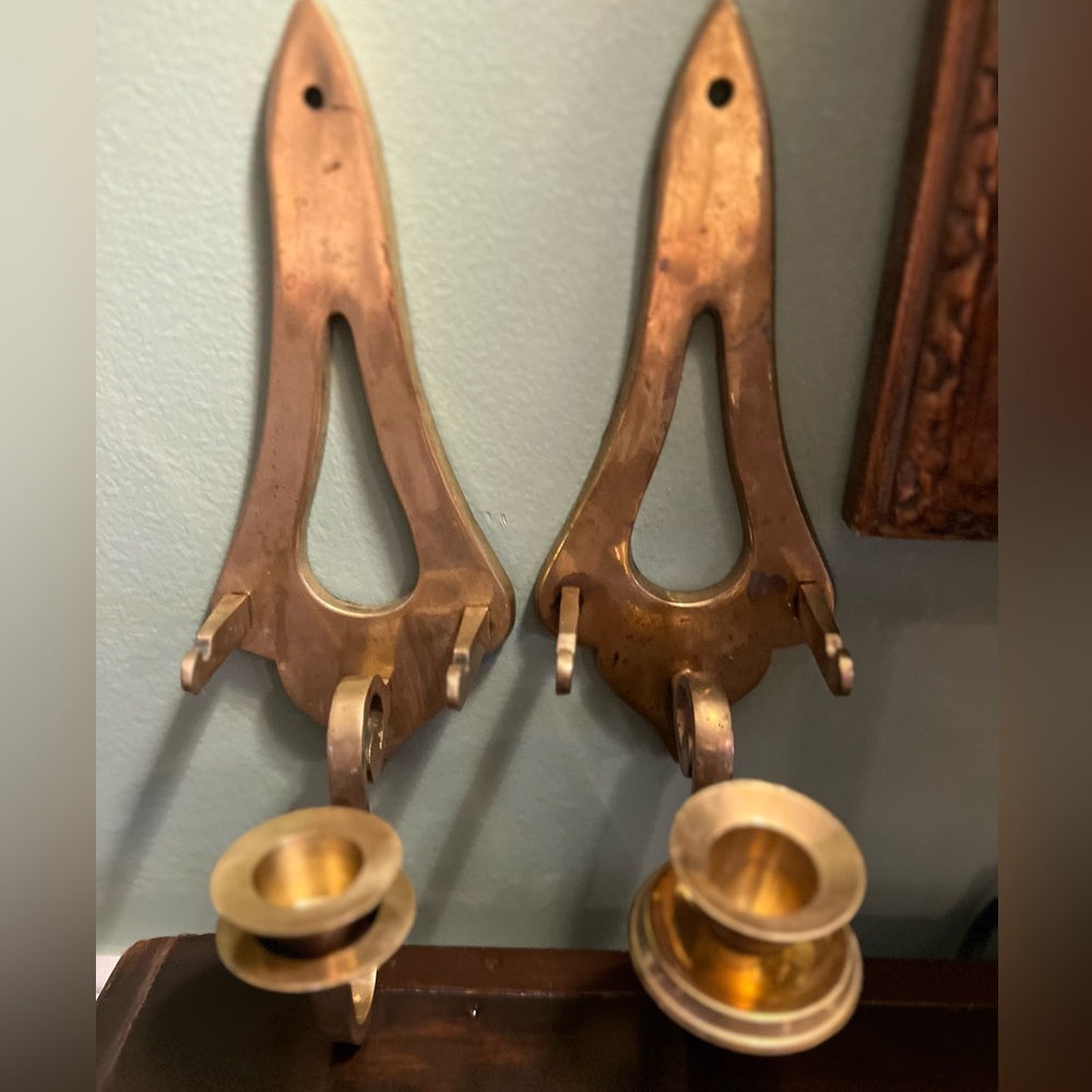 Brass wall sconces that hold plates